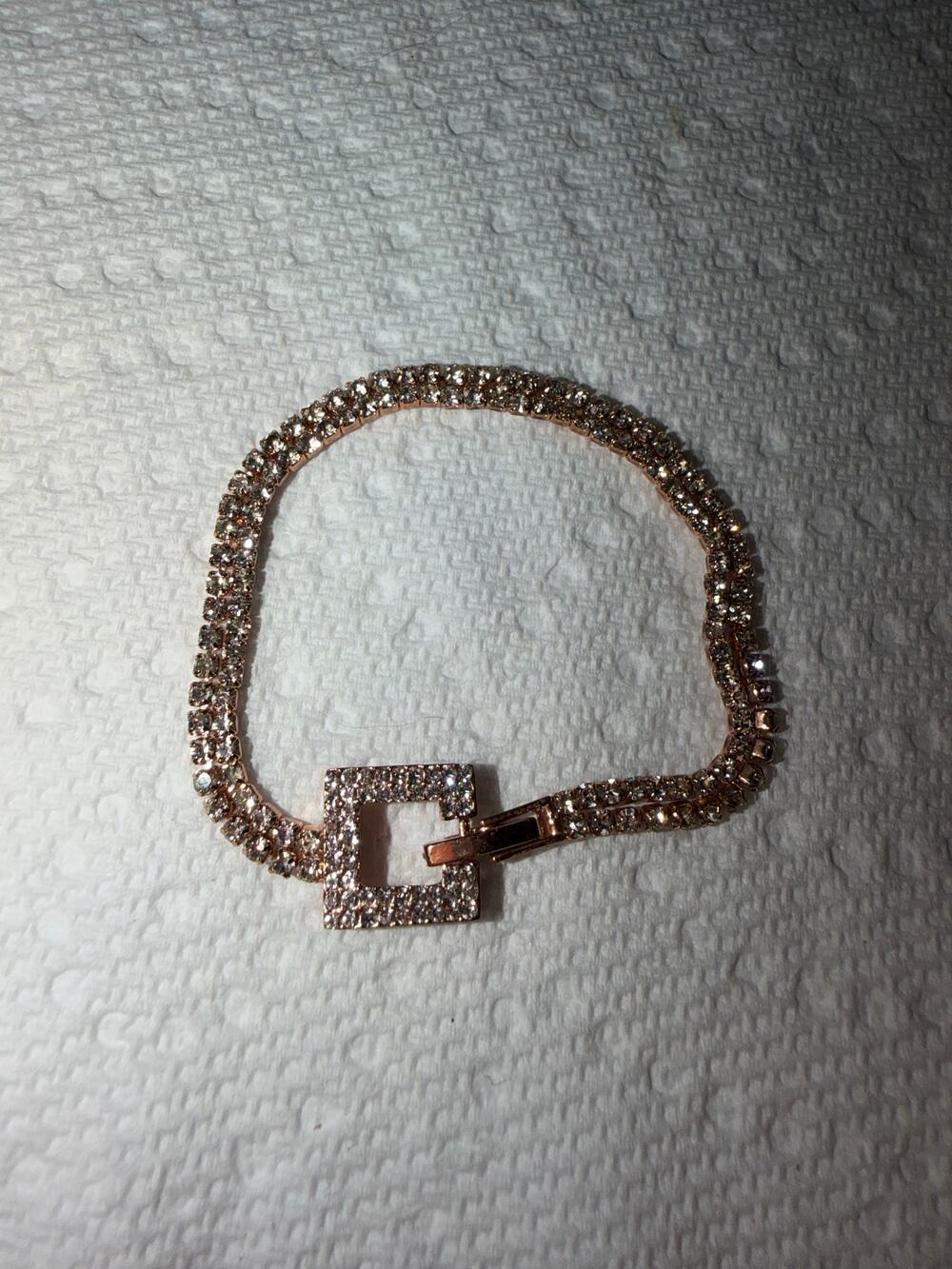 Rose gold tone double row rhinestone tennis bracelet with square buckle clasp